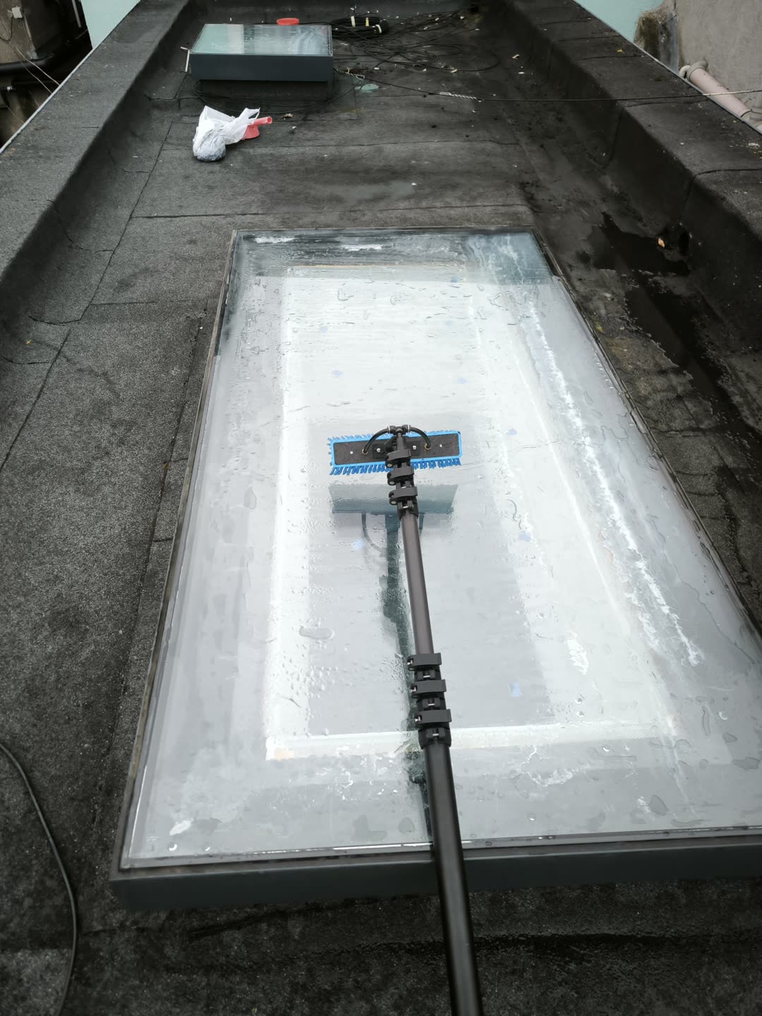 Water-fed pole brush cleaning a flat rooflight skylight in Kilkenny